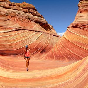 Photograph of a woman walking through a desert