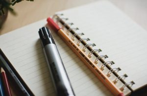 Photograph of two pens on top of an open notebook
