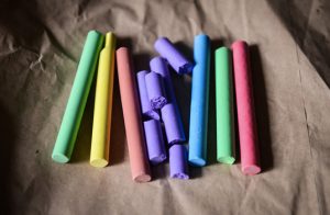 Various colors of chalk with some pieces broken